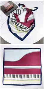 Macro detail of piano keyboard silk scarf in navy and burgundy artistic pattern