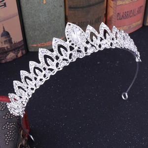 Detail of silver leaf tiara with rhinestones placed on a vintage book backdrop