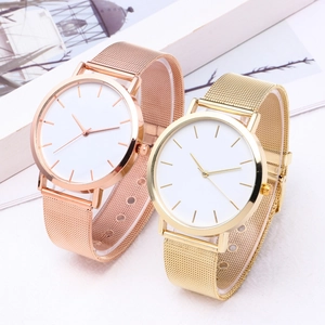 Close-up of minimalist mesh band watches in rose gold and gold finishes with white dials