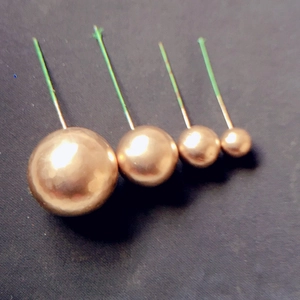 Vue détaillée de quatre tailles assorties de boules dorées pour décoration de gâteaux