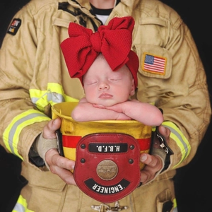 Newborn photography prop: large red textured bow headband in firefighter helmet