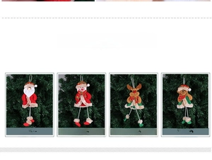 Detail of four plush Christmas ornaments including Santa and Snowman on a tree