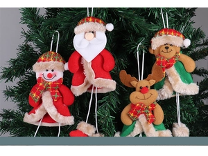 Close-up of Santa and snowman plush ornaments hanging on a green Christmas tree