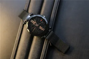 Macro detail of starry sky dial with rose gold Roman numerals and magnetic mesh band