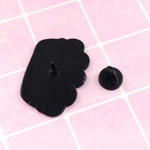 Black enamel cat brooch back view with durable rubber pin clutch and metal needle