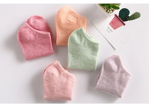 Flat lay of five pairs of pastel cotton ankle socks in pink orange green and purple colors