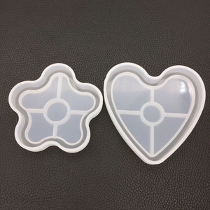 Detail of star and heart-shaped silicone resin molds with cross support on leather