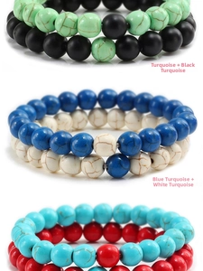 Detail of beaded bracelet sets featuring matte black stones and turquoise with vein textures