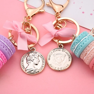 Chic three-layer macaron keychain with golden coins and a pink bow accessory