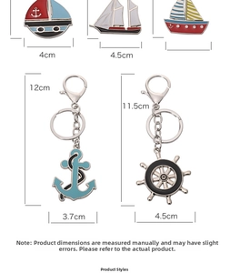 Detailed size view of nautical keychain set featuring anchor, rudder and sailboat charms