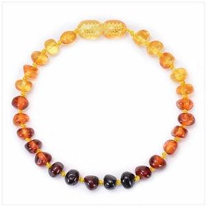 Macro shot of natural Baltic amber beads in a multi-color gradient with a screw clasp