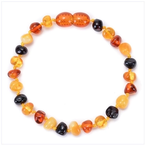 Macro view of multi-color Baltic amber beads in honey, cognac and cherry tones
