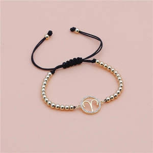 Detail of adjustable Aries zodiac bracelet with gold beads and micro-pave crystals