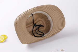 Detail of straw cowboy hat interior showing woven texture and adjustable black chin strap