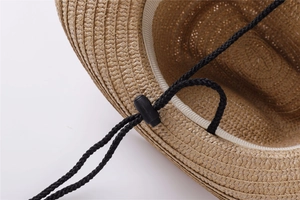 Detail of woven straw hat interior featuring a comfortable sweatband and adjustable wind rope