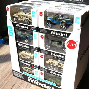 Macro detail of military die-cast 1:64 scale toy trucks in their individual retail packaging