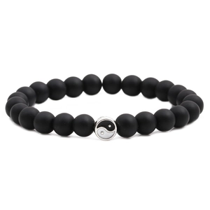 Matte black distance bead bracelet with Tai Chi Yin Yang charm on white background