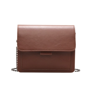 Vintage brown leather flap square bag with wide metal chain strap on white background