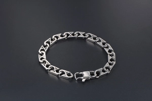Close-up of mesh titanium steel bracelet with interlocking links and lobster clasp
