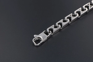 Detail of silver mesh bracelet showing sturdy lobster clasp and polished steel links