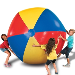 Giant colorful inflatable beach ball with children playing against a white background