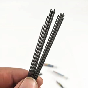 Close-up of a hand holding 2B resin mechanical pencil leads for size comparison