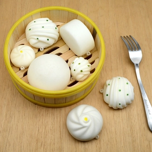 Detailed set of realistic steamed bun squishies in a miniature bamboo steamer basket
