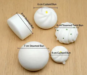 Flat lay of artificial steamed bun toy set with size labels on light wood background