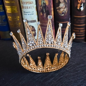 Detail of vintage gold bridal crown with sparkling rhinestones on antique books