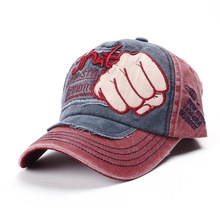 Detailed view of red and blue patchwork baseball cap with distressed embroidery patch