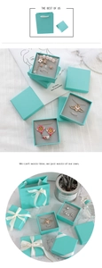 Detailed view of Tiffany blue jewelry gift box with white satin ribbon and matching bag
