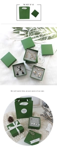 Detailed view of dark green jewelry gift packaging set with paper bag and boxes