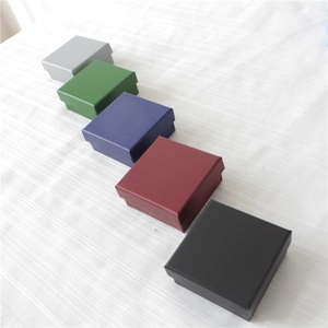 Minimalist square jewelry gift boxes in five matte colors on a white textured background