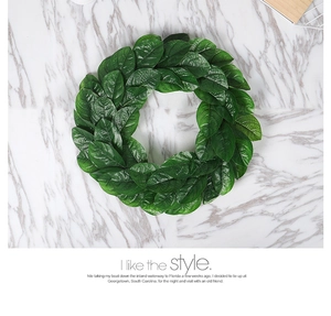 Detailed view of artificial magnolia leaf wreath with lush green foliage and clear texture