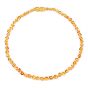 Macro shot of circular Baltic amber beaded baby necklace with screw clasp on white background