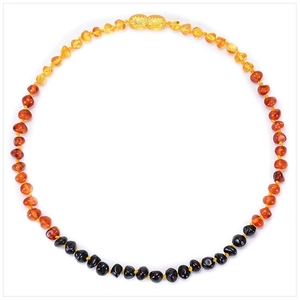 Detail of amber baby necklace with gradient beads and secure golden screw clasp