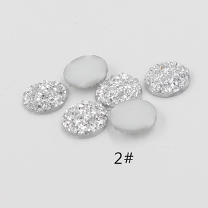 Close-up of 6 silver resin druzy glitter cabochons showing textured surface and flat white back