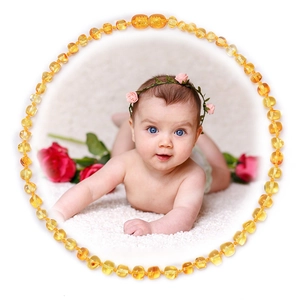 Natural Baltic amber necklace for babies featuring round beads in golden and honey hues