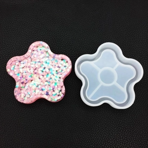 Detail of five-petal flower silicone mold with sparkling pink resin coaster craft