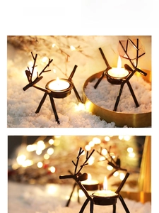 Close-up of black iron reindeer candle holders with tea lights in warm festive setting