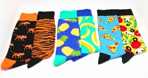 Close-up of colorful cotton socks set featuring tiger, fruit, and pizza knit patterns