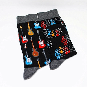 Detailed view of music themed socks featuring electric guitars and artistic musical notes