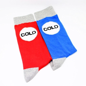 Detailed knit texture of red and blue cotton socks featuring COLD lettering