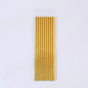 Macro shot of metallic gold spiral paper straws in a clear plastic package on white background