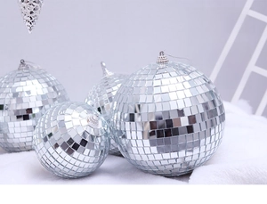 Silver mirror disco balls in various sizes on plush background with hanging hooks