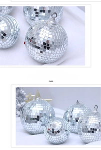 Silver mirror disco balls in various sizes with metal hanging loops on white fur