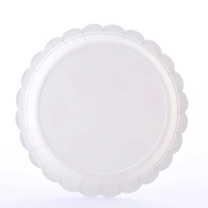 Top view of a round white disposable paper plate with decorative scalloped petal edges