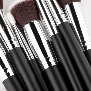 Macro detail of high-quality makeup brushes with soft fibers and matte black wooden handles