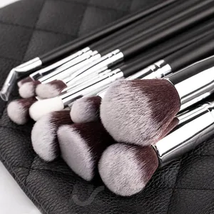 15pcs makeup brush set with matte black handles and silver ferrules on quilted background