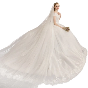 Elegant French off-shoulder white wedding gown with intricate lace embroidery and long train